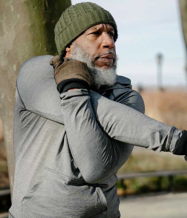 Man stretching his legs, showing flexibility in a calm environment.